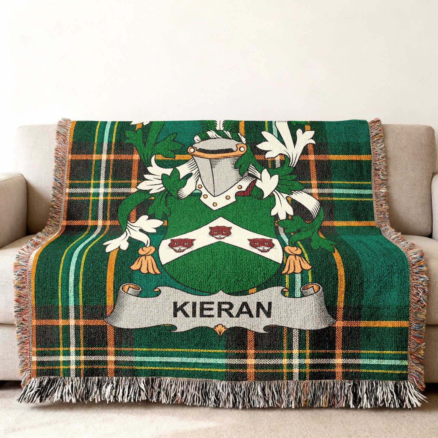 Kieran family crest on green plaid woven throw blanket on sofa.
