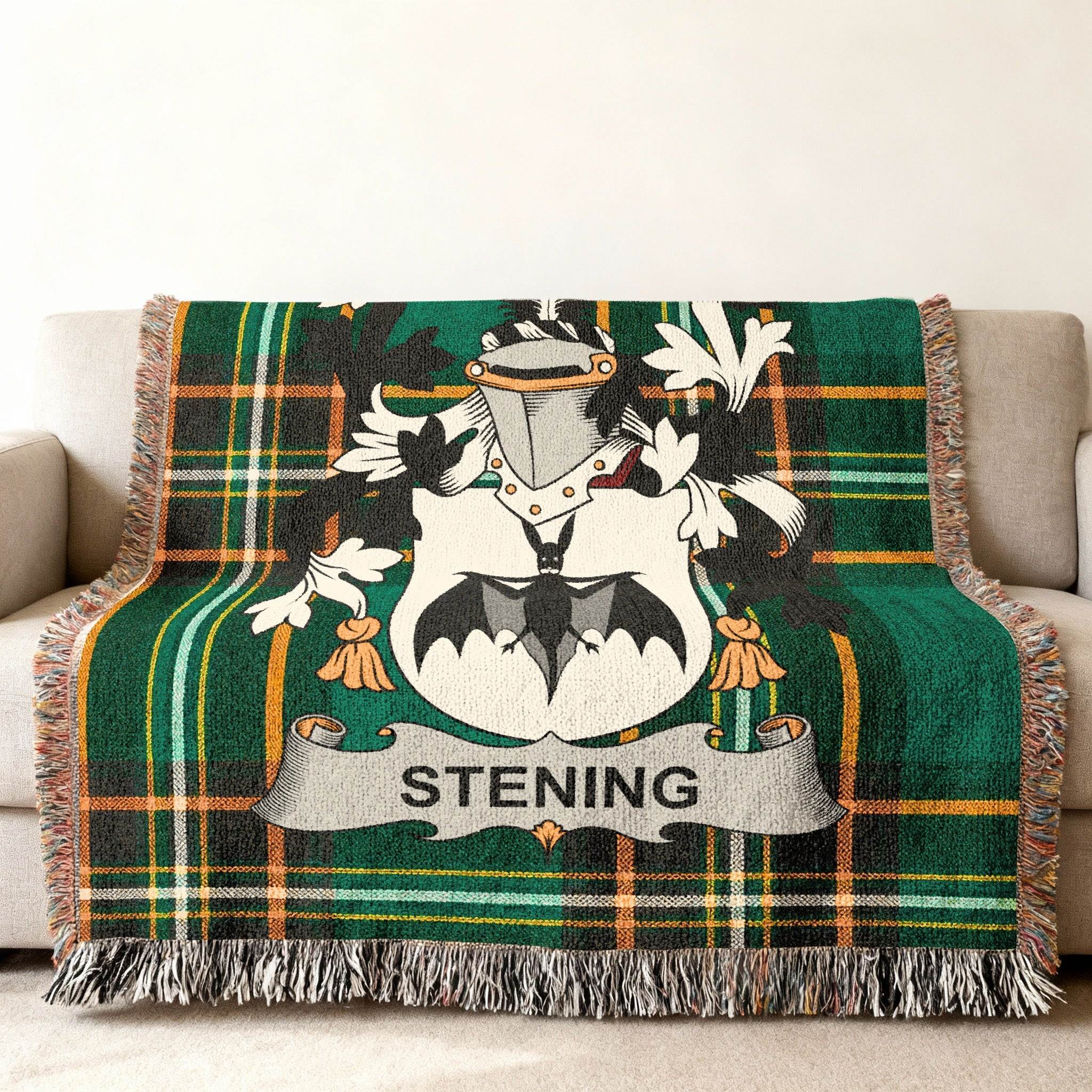 Green plaid throw blanket with a family crest and "STENING" text.