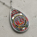 Macbain clan badge necklace with tartan background and motto.