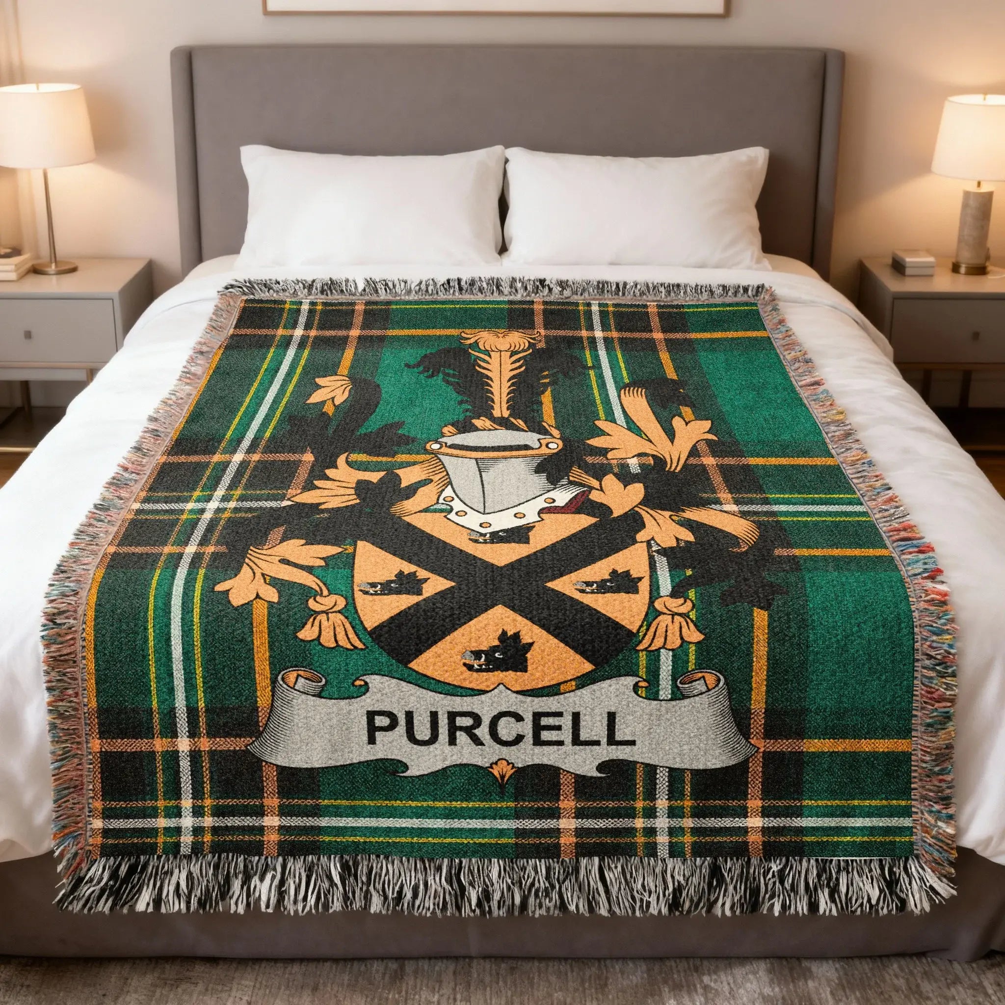 Purcell clan crest on a green plaid wool blanket on a bed.