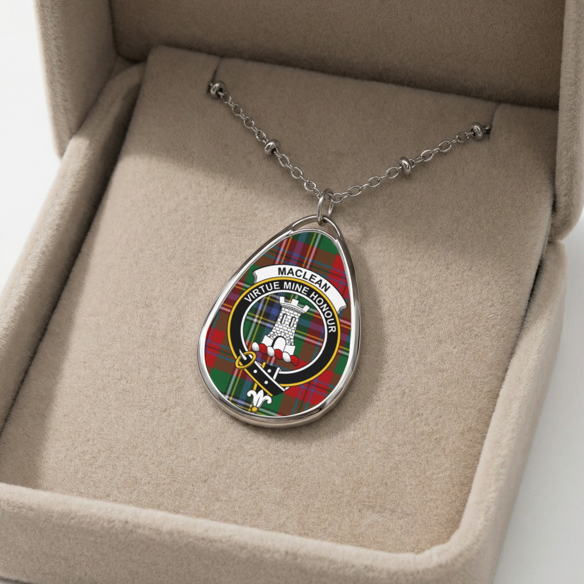 Oval pendant necklace with Maclean clan crest and tartan pattern on beaded chain in jewelry box.