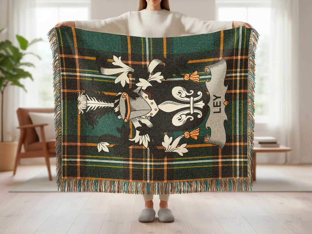 Tartan blanket with coat of arms and "LEY" text.