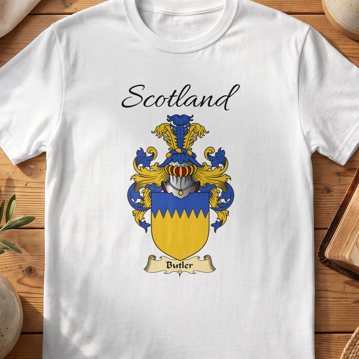 White Butler Scottish family shield T-shirt featuring a gold shield beneath a blue zigzag top band