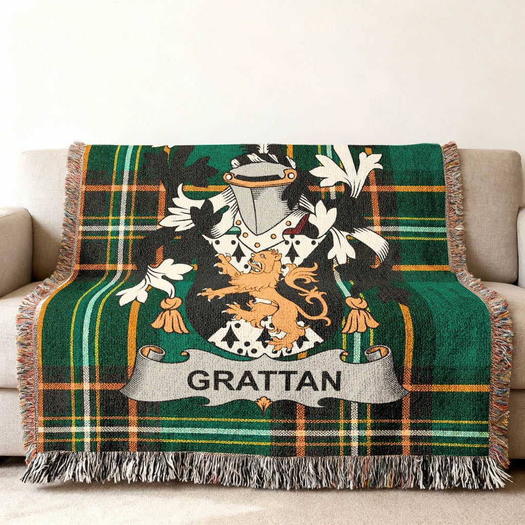 Green plaid throw blanket with Grattan family crest displayed in the center.