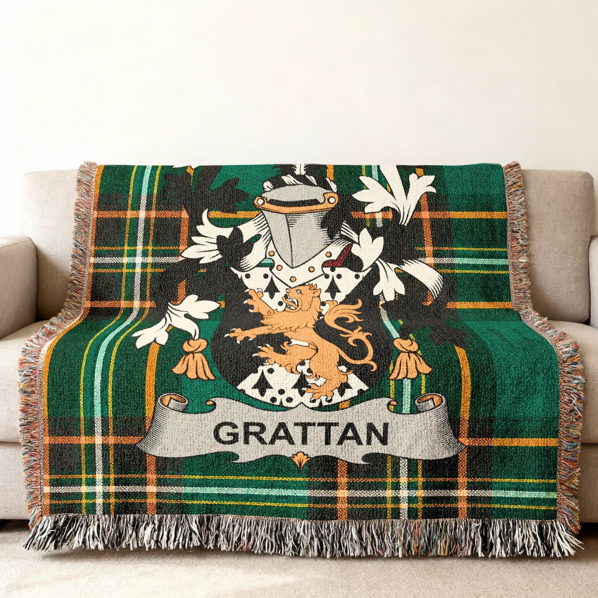 Green plaid throw blanket with Grattan family crest displayed in the center.