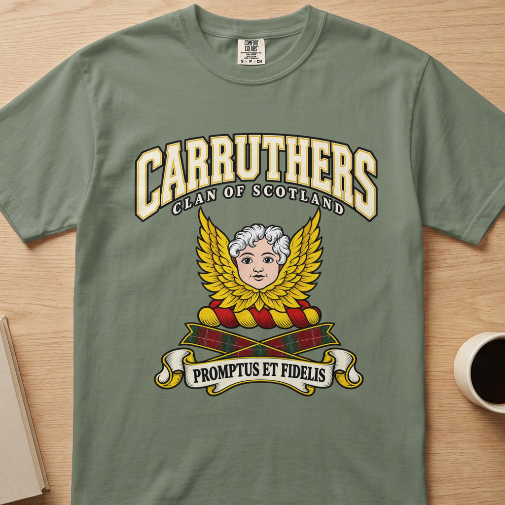 Carruthers pale face framed by golden wings graphic on a sage green Comfort Colors T-shirt, front view