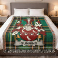 Tartan blanket with Gunning coat of arms draped on a bed.