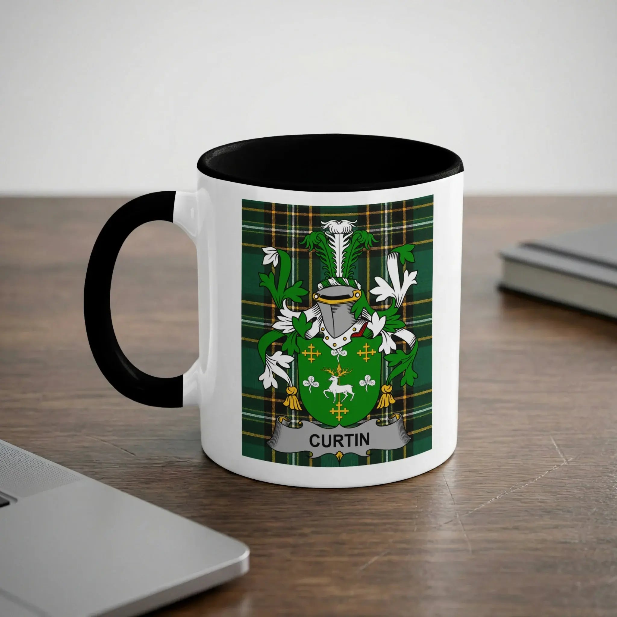 White mug with black handle featuring the Curtin family crest on a green plaid background.