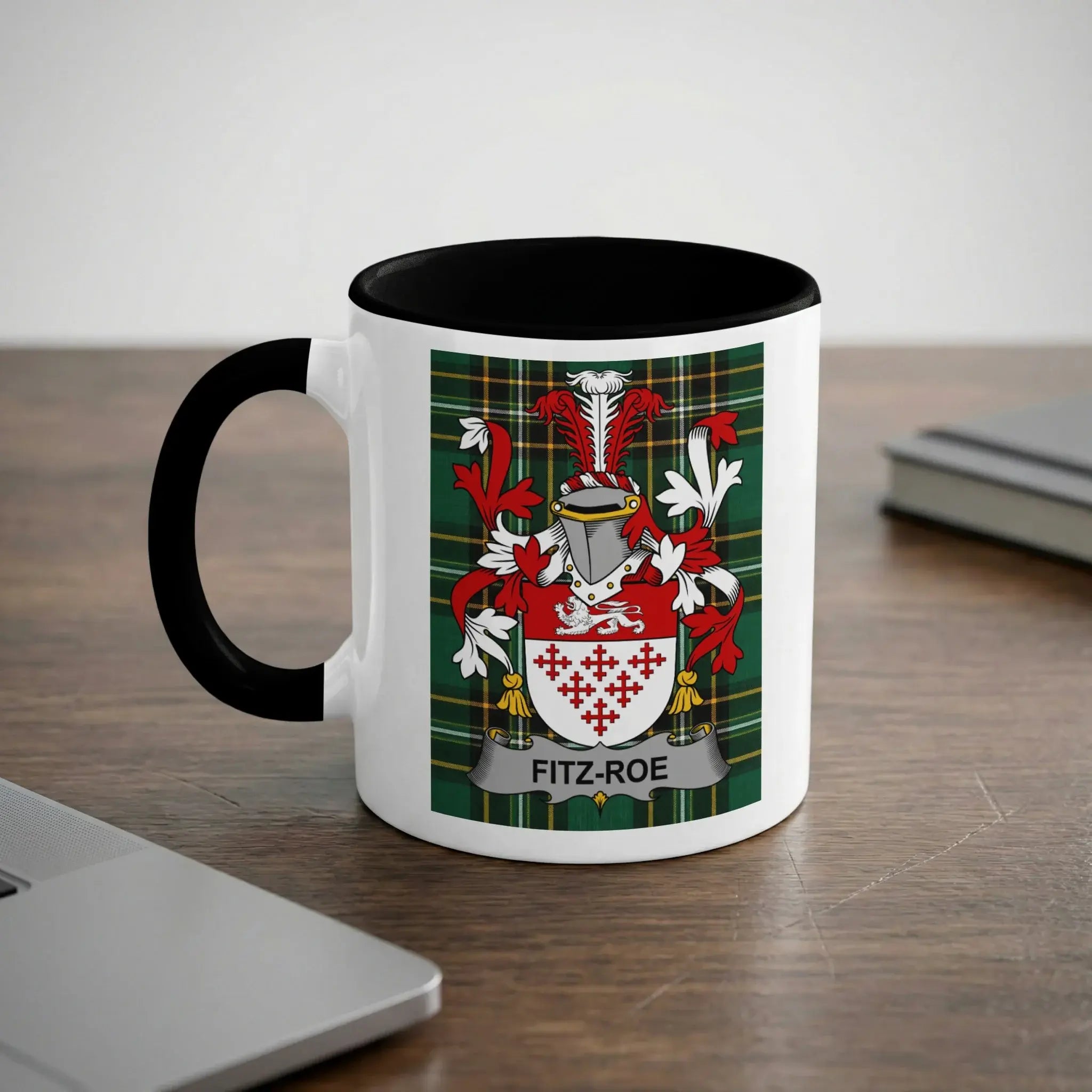 White mug with black rim featuring Fitz-Roe family crest on a plaid background.