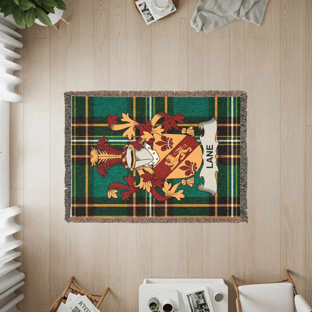 Woven blanket with Lane family crest and green, yellow, and red plaid design.