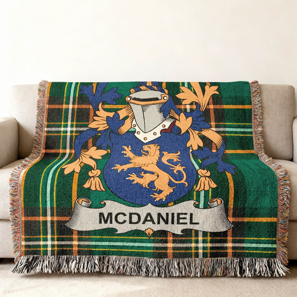 McDaniel family crest on a green plaid woven throw blanket.