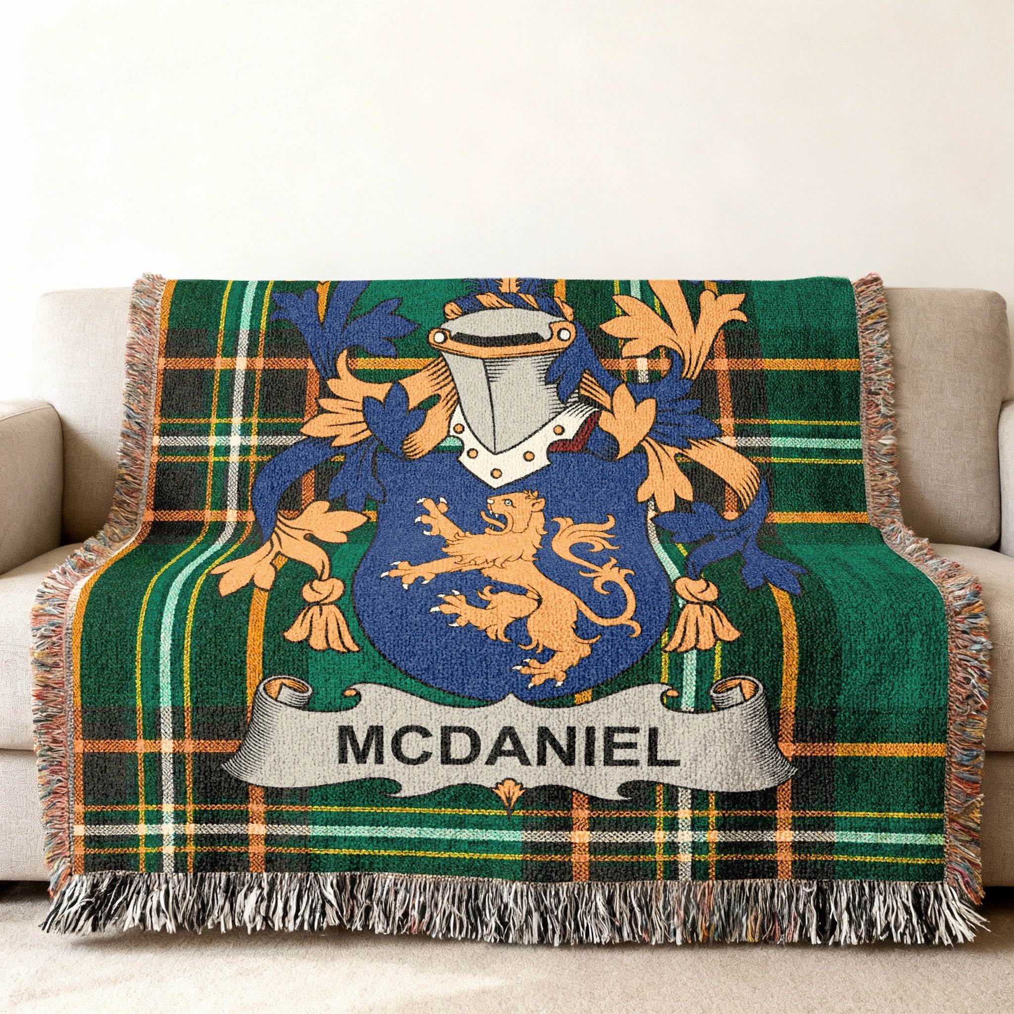McDaniel family crest on a green plaid woven throw blanket.