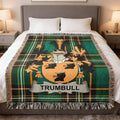 Trumbull crest on green plaid throw blanket on a bed.