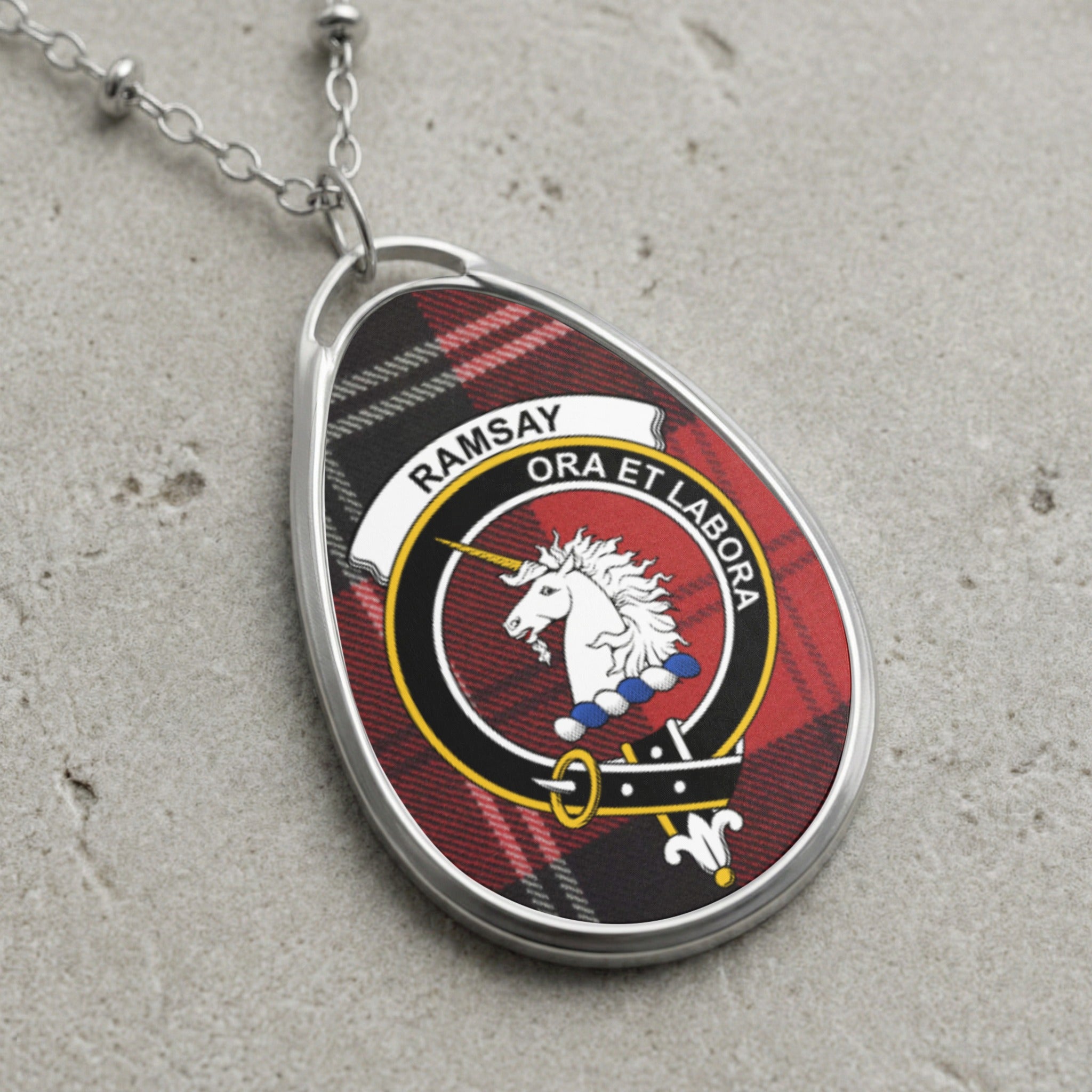 Ramsay clan Scottish tartan necklace with clan crest and Ora Et Labora motto on tartan background