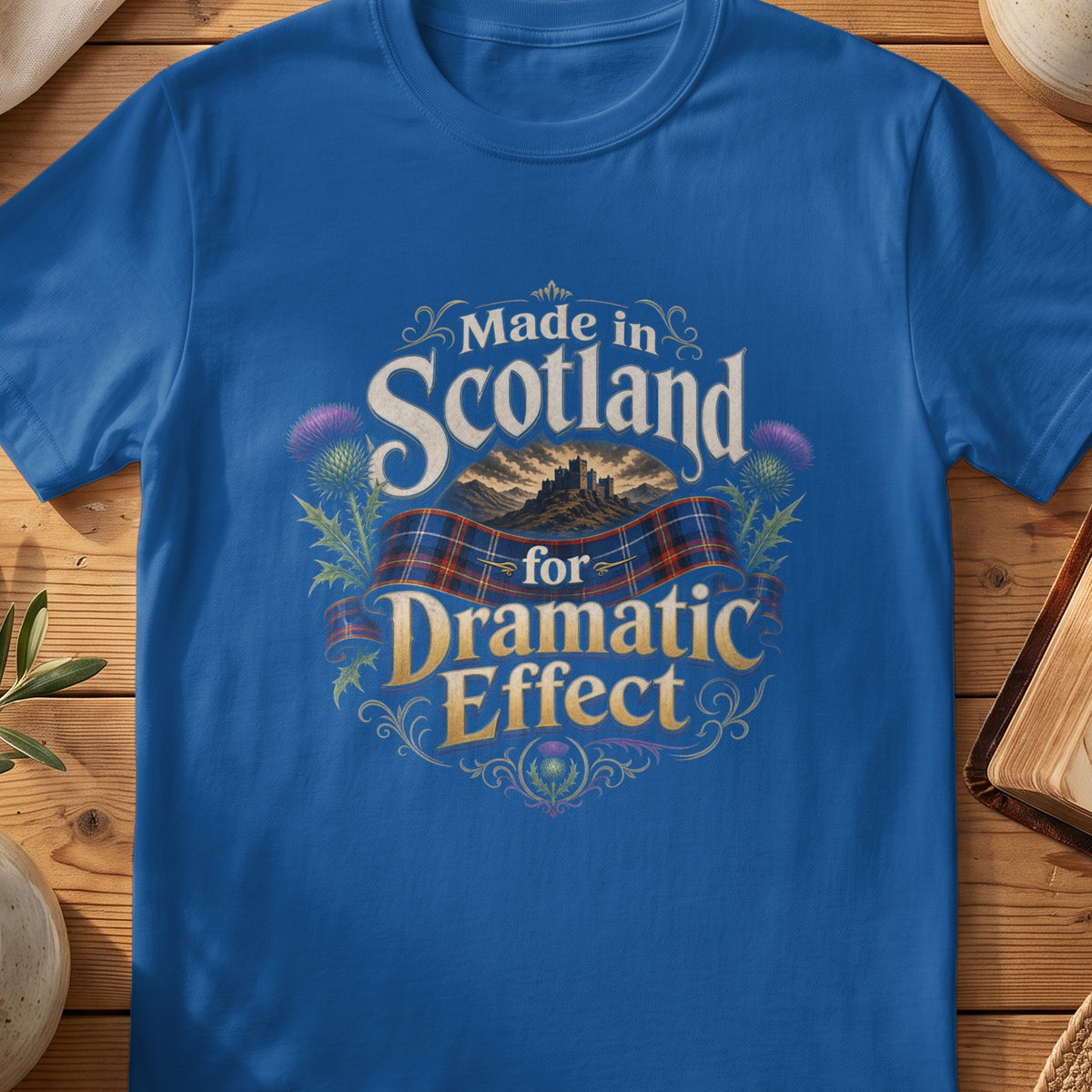 Blue t-shirt with "Made in Scotland for Dramatic Effect" text and Scottish thistle.