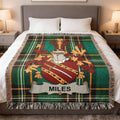 Tartan throw blanket with a shield crest and "MILES" banner.