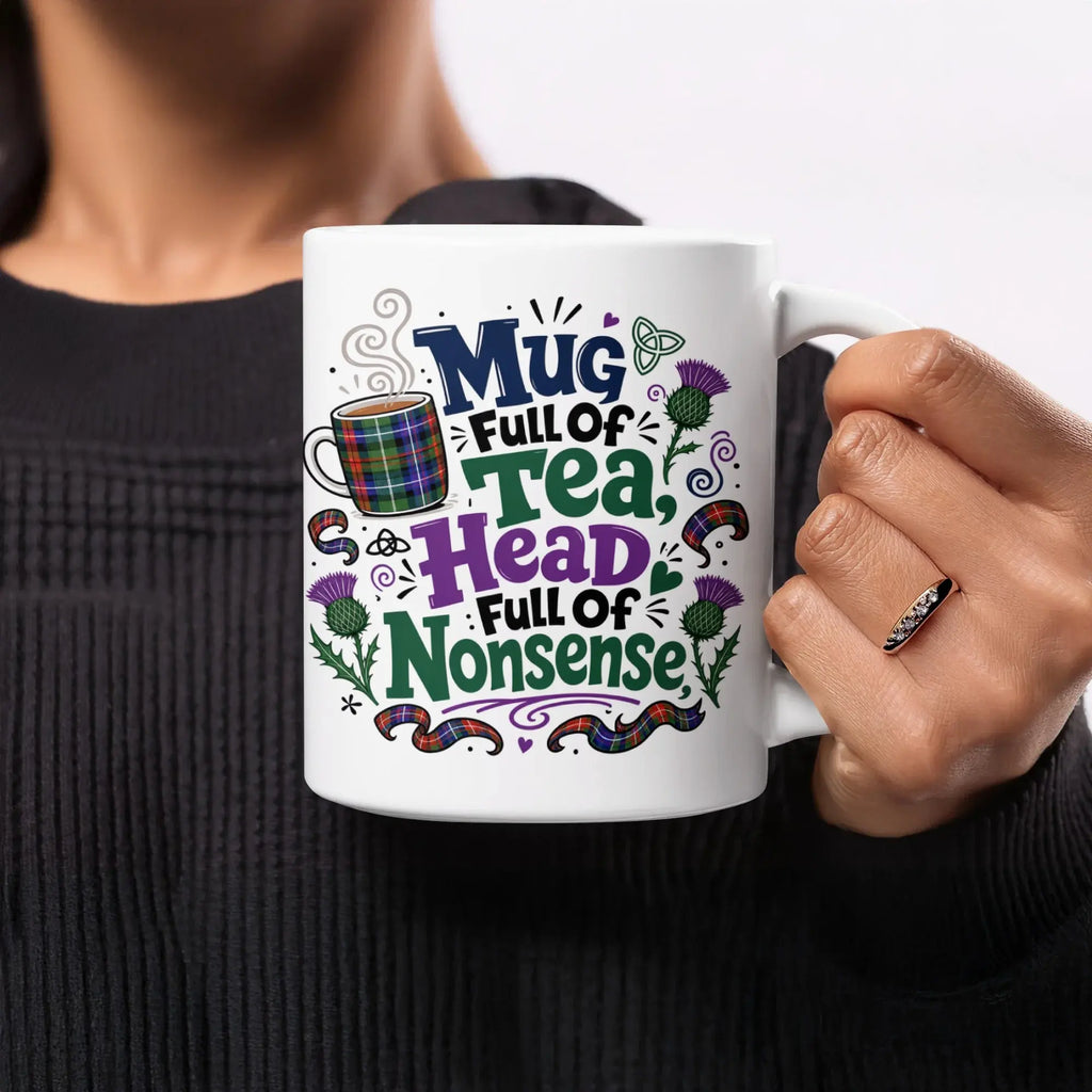 White mug with "Mug Full of Tea, Full of Nonsense" text and plaid pattern.