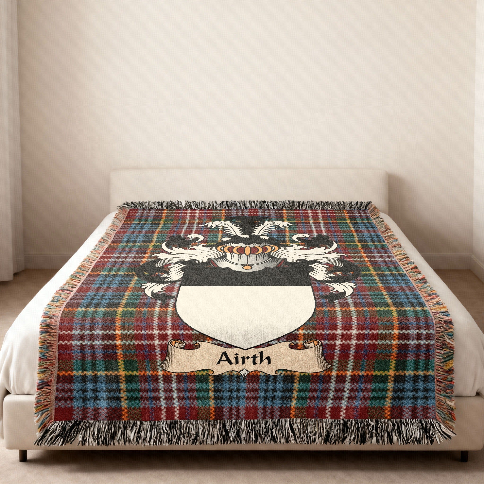 Airth family crest emblem on a Caledonia tartan woven blanket