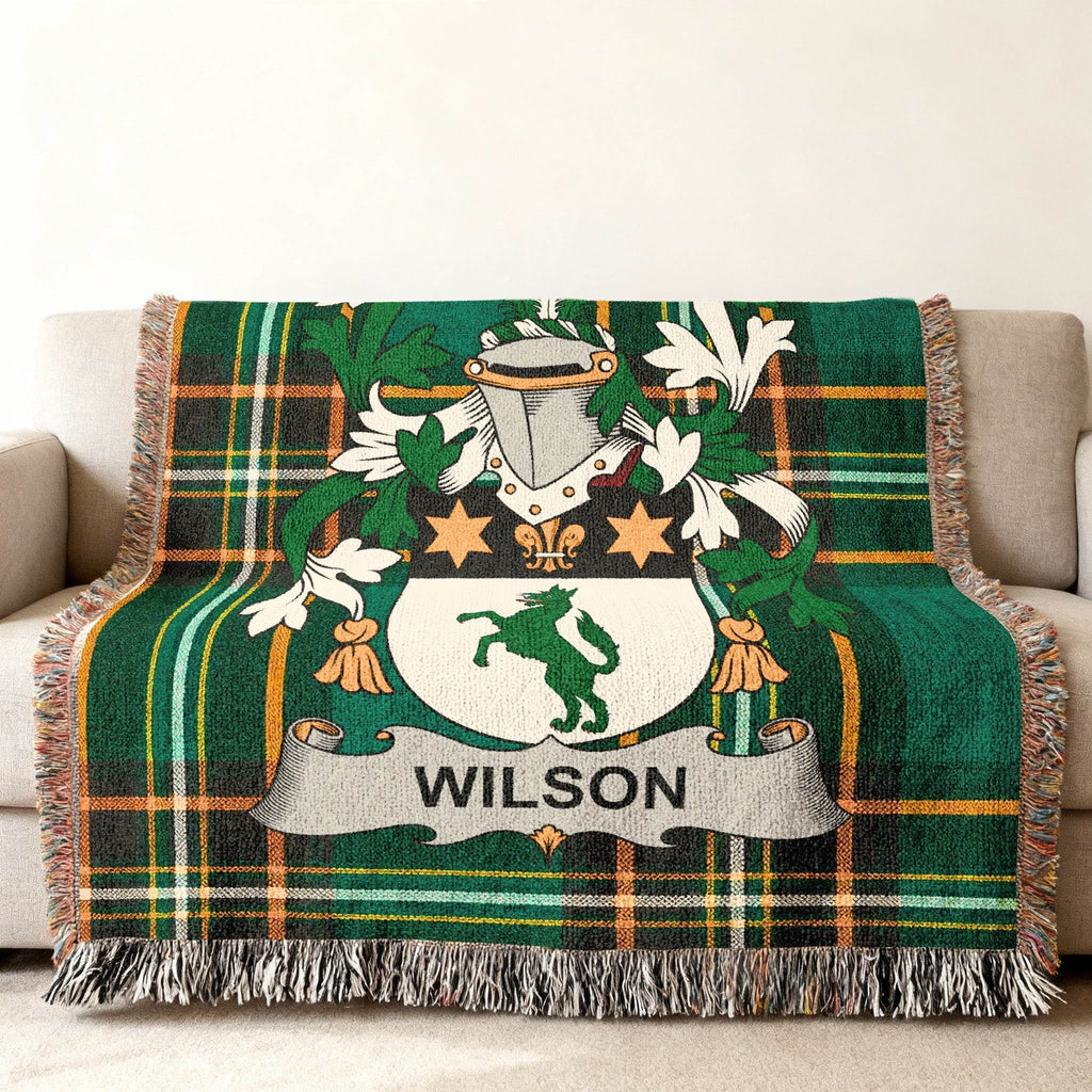 Green plaid woven throw blanket with Wilson family crest.