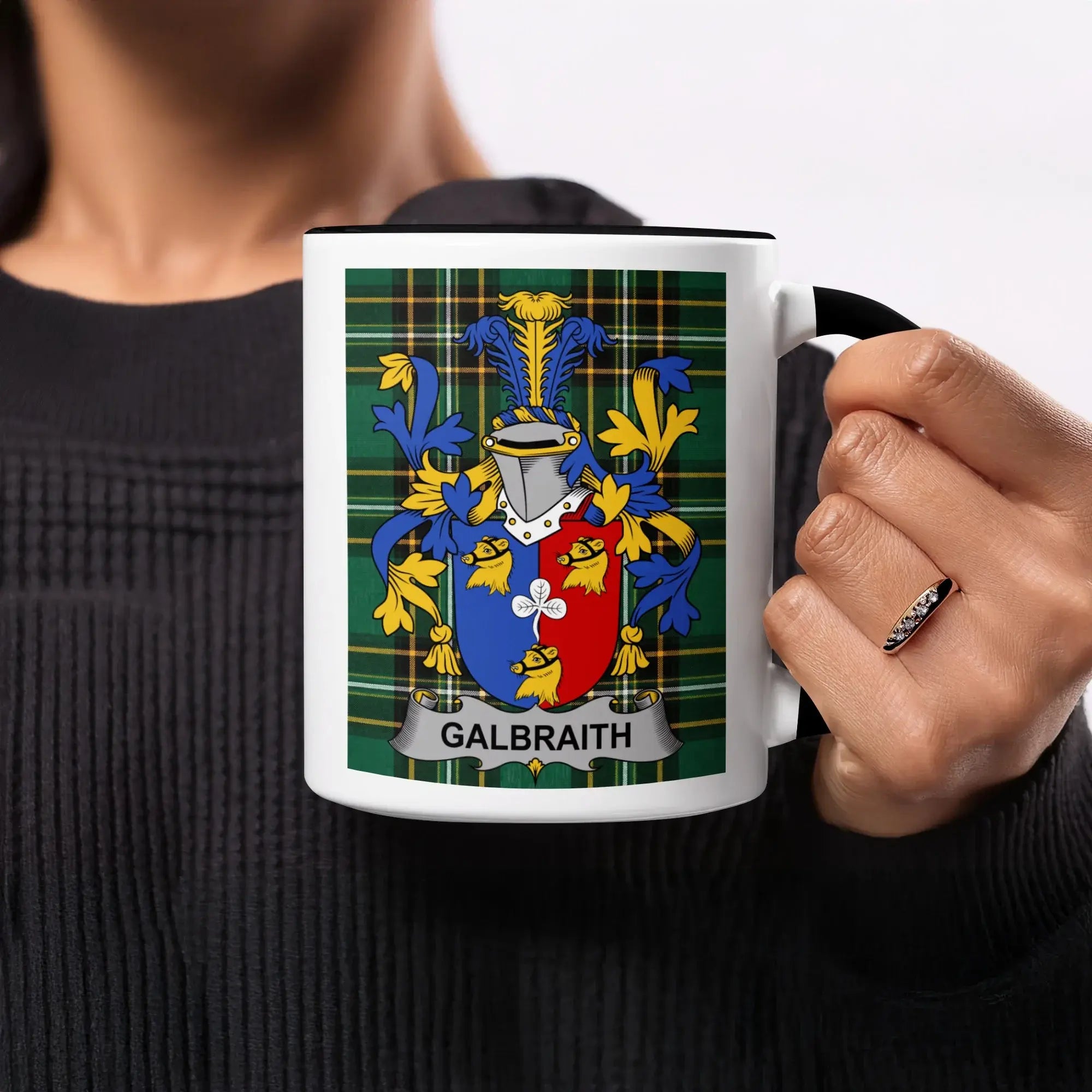 Black mug with Galbraith family crest on plaid background.