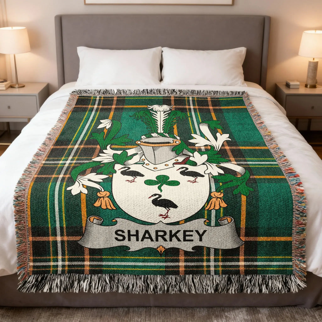 Green tartan throw blanket with the Sharkey family crest in white.