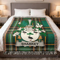 Green tartan throw blanket with the Sharkey family crest in white.