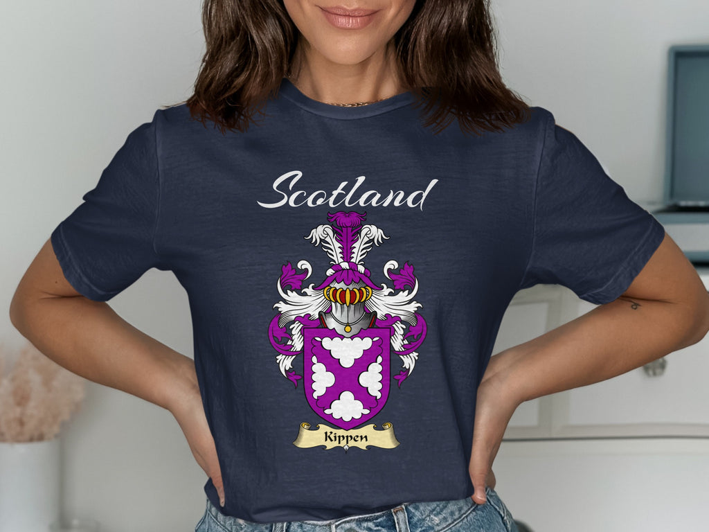 Model wearing a navy Kippen T-shirt featuring white decorative motifs on a purple shield