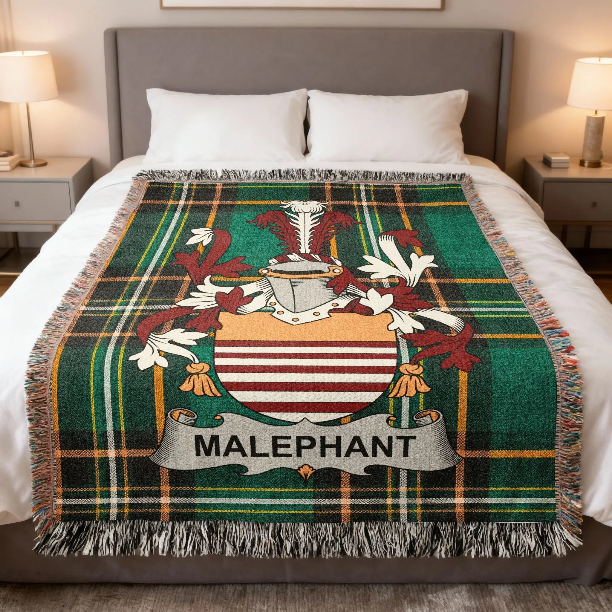 Plaid blanket with Malaphan coat of arms centered on a bed.