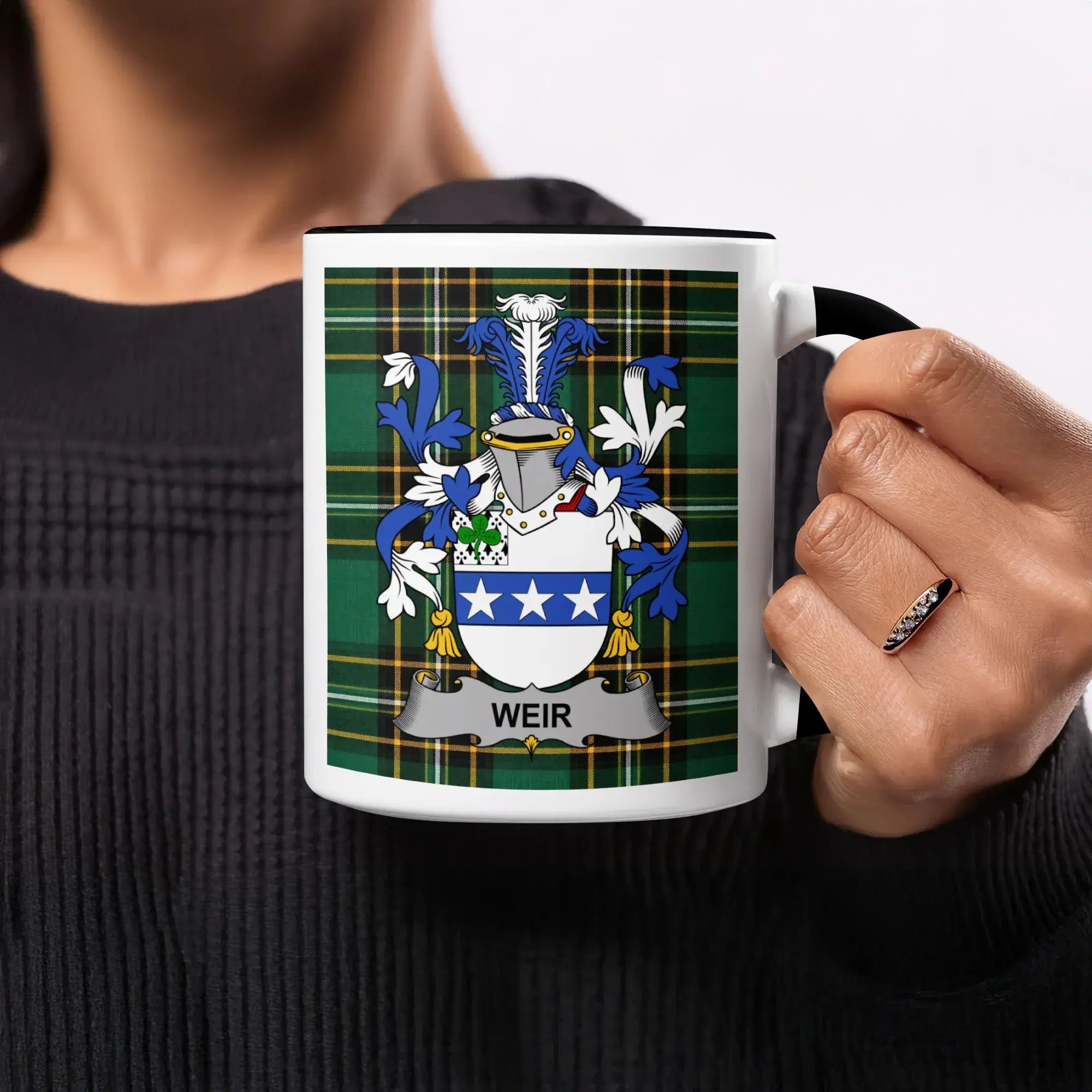 Mug with Weir family crest on green plaid background.