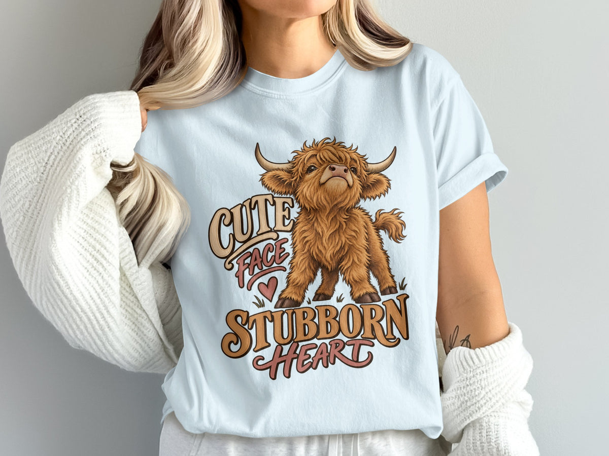 Model wearing the Cute Face, Stubborn Heart Highland cow Comfort Colors T-shirt in Chambray
