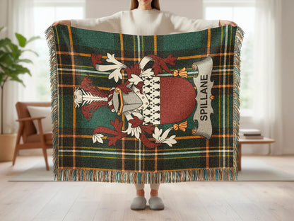 Tartan blanket with crest and "SPILLANE" banner, held by person.