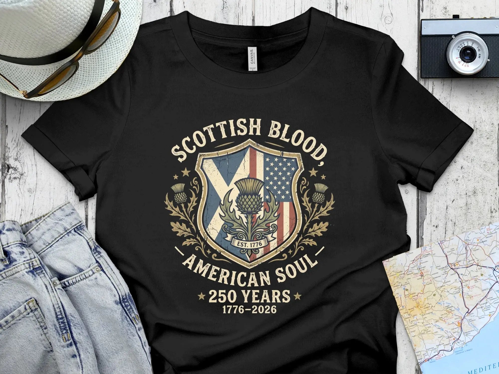 Black t-shirt with Scottish and American flag design and "Scottish Blood, American Soul" text.