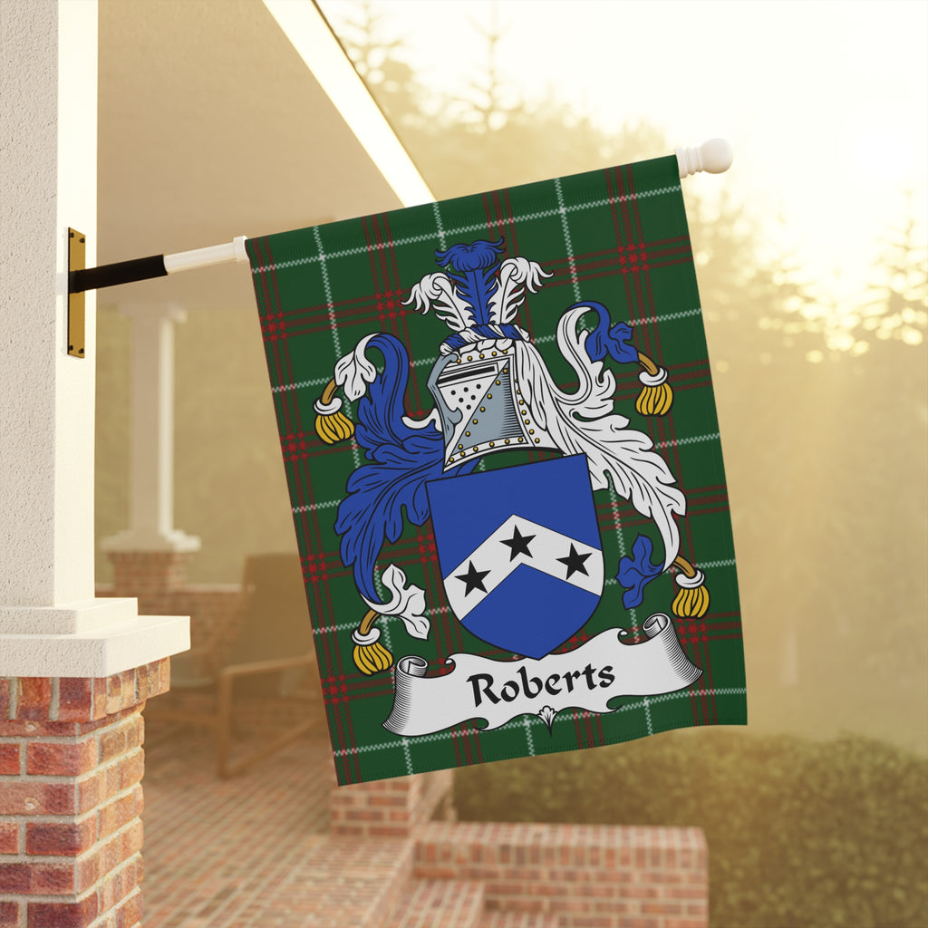 Roberts family crest on a green tartan flag displayed outdoors.
