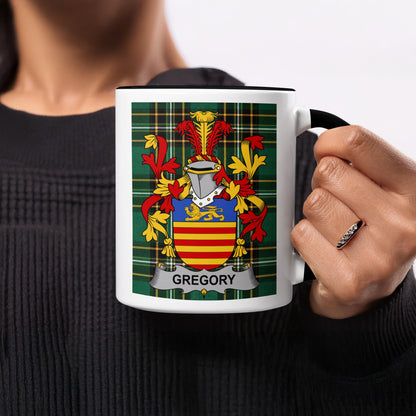 Tartan mug with Gregory family crest, held by a person.