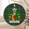 Marshal ornament hanging from a pale wooden branch, showing a red lion on a gold-and-green divided shield on Welsh National Tartan.
