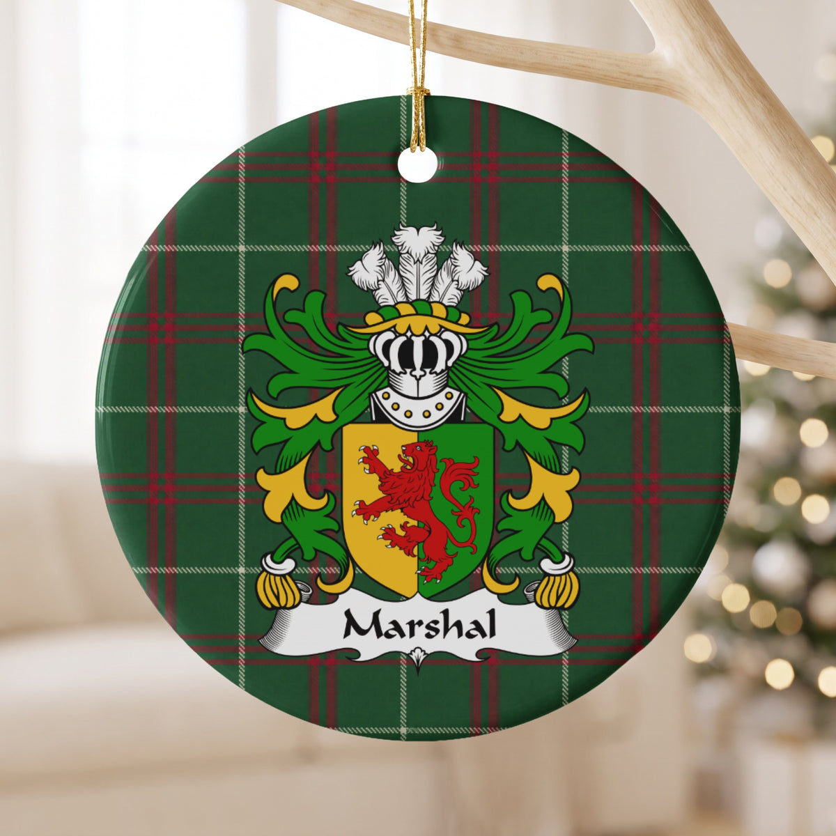 Marshal ornament hanging from a pale wooden branch, showing a red lion on a gold-and-green divided shield on Welsh National Tartan.