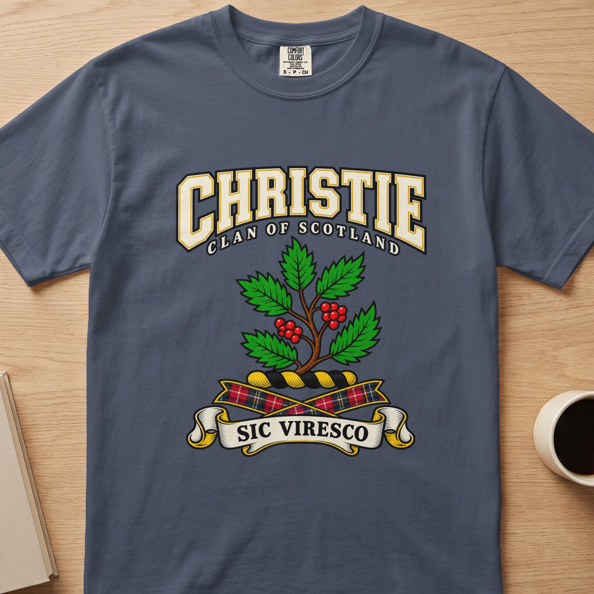 Christie clan T-shirt in slate blue, front view with green leafy branch with red berries