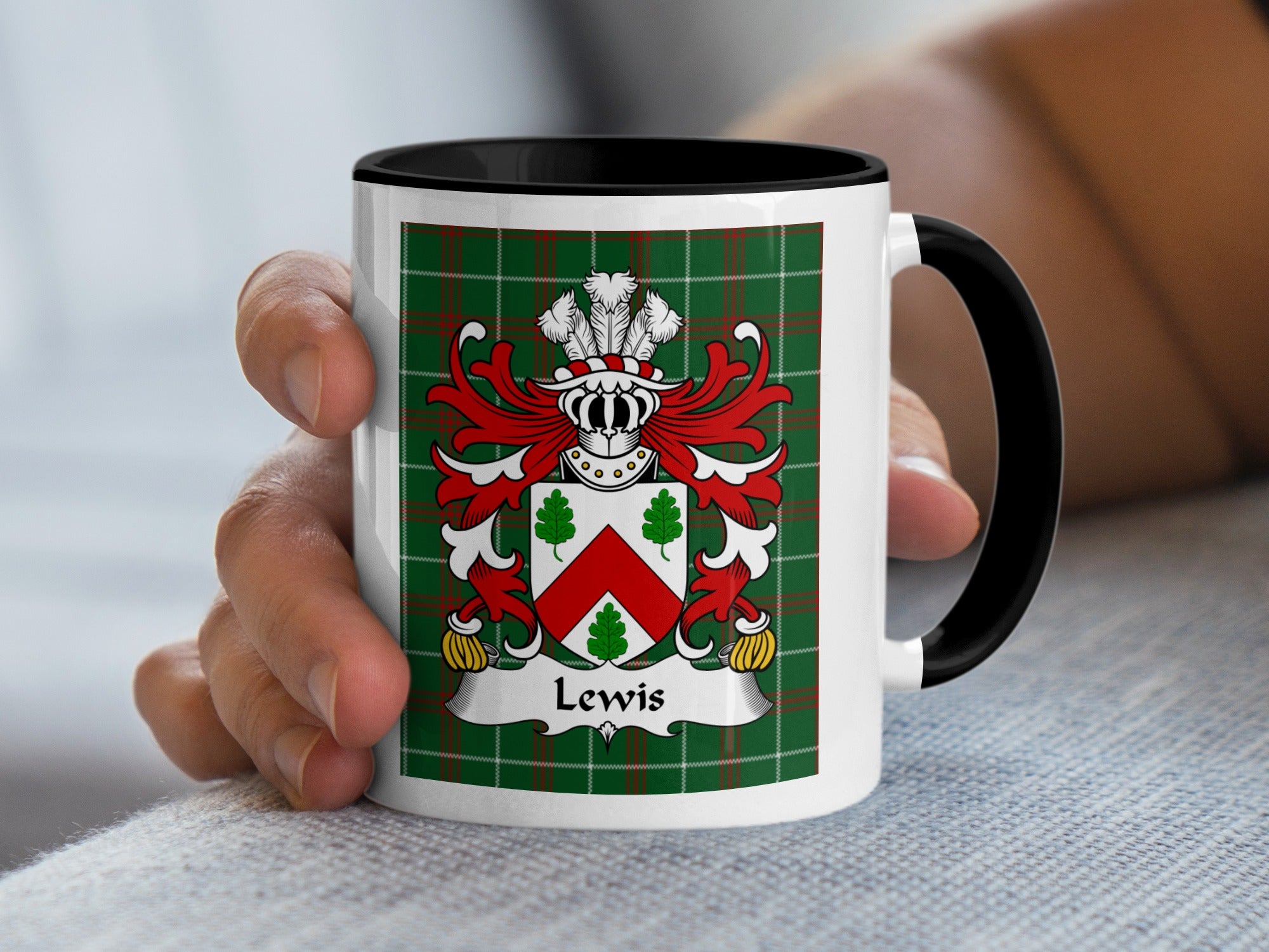 White mug with black handle displaying Lewis family crest on green tartan background.