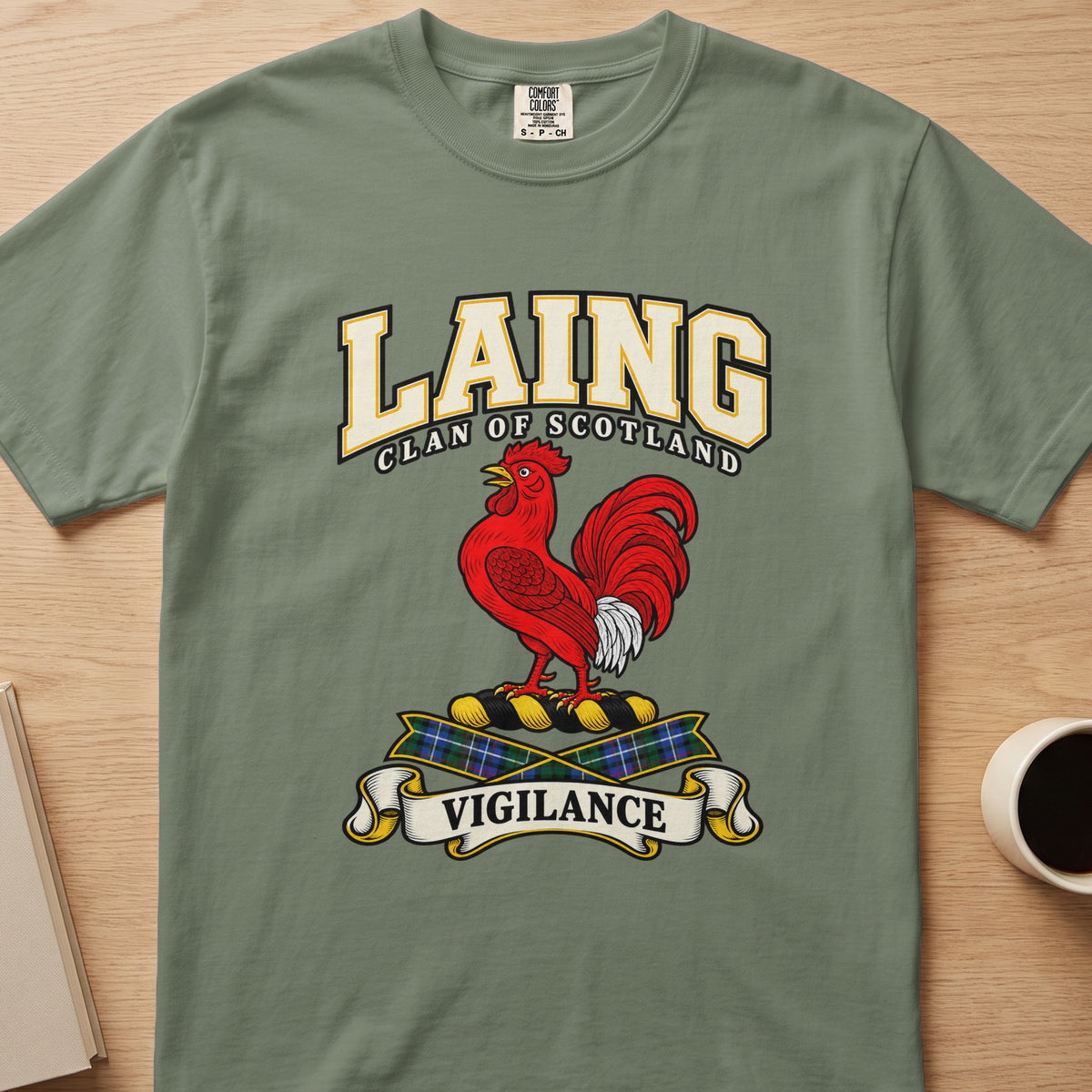 Laing clan crest with red rooster and Vigilance scroll on a sage green Comfort Colors T-shirt, front view