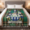 Tartan throw blanket with Hackett family crest featuring shields and fish.