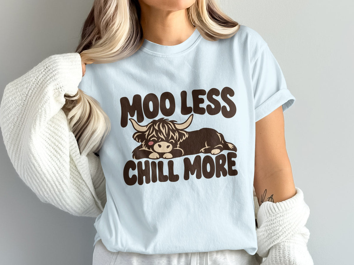 Model wearing the Moo Less, Chill More Highland cow Comfort Colors T-shirt in Chambray