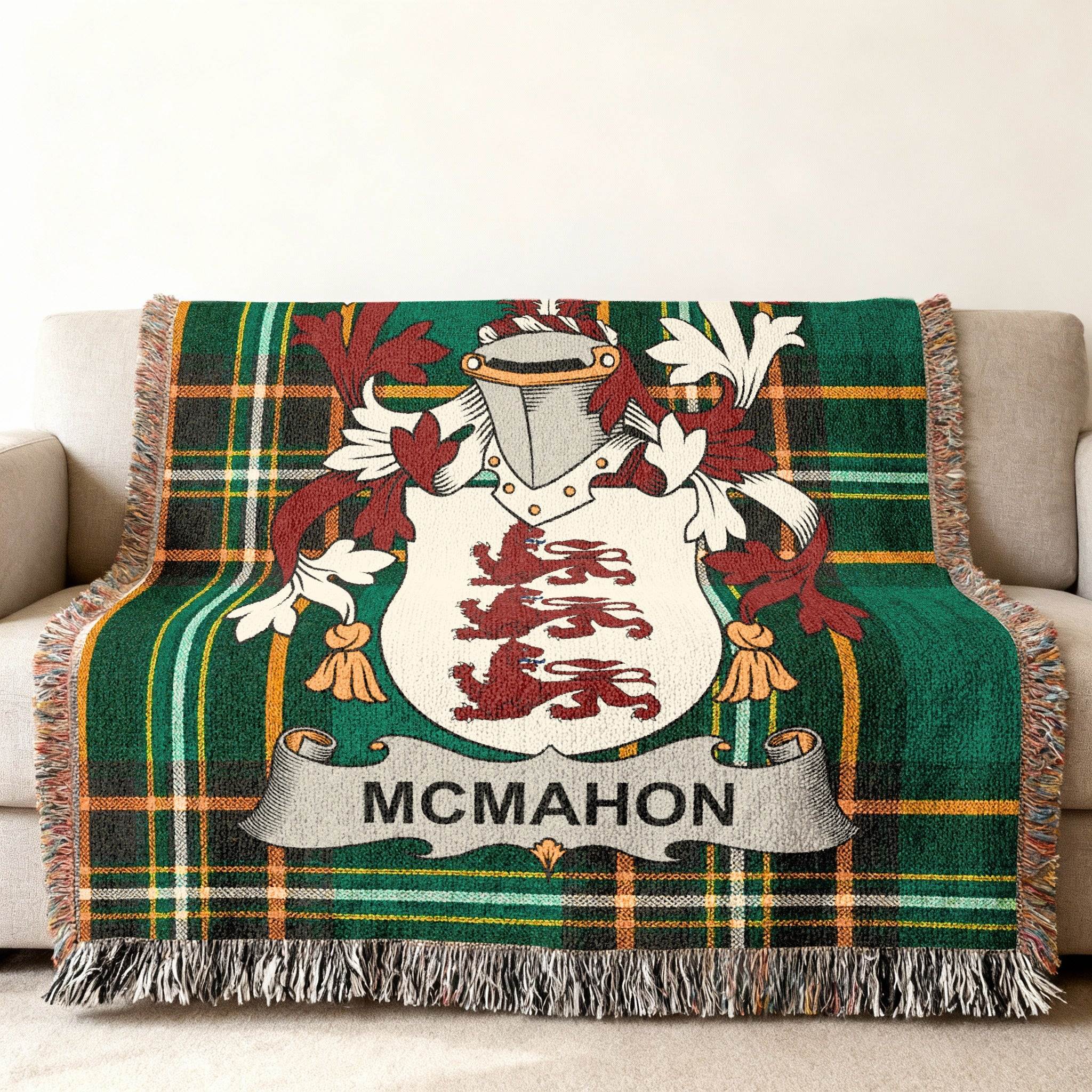 McMahon tartan blanket with coat of arms draped on a sofa.