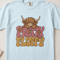 Pretty Fluffy Highland cow design on a Chambray Comfort Colors 1717 T-shirt, flat lay