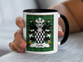 Mug with Cooke family crest on green tartan background held by a hand