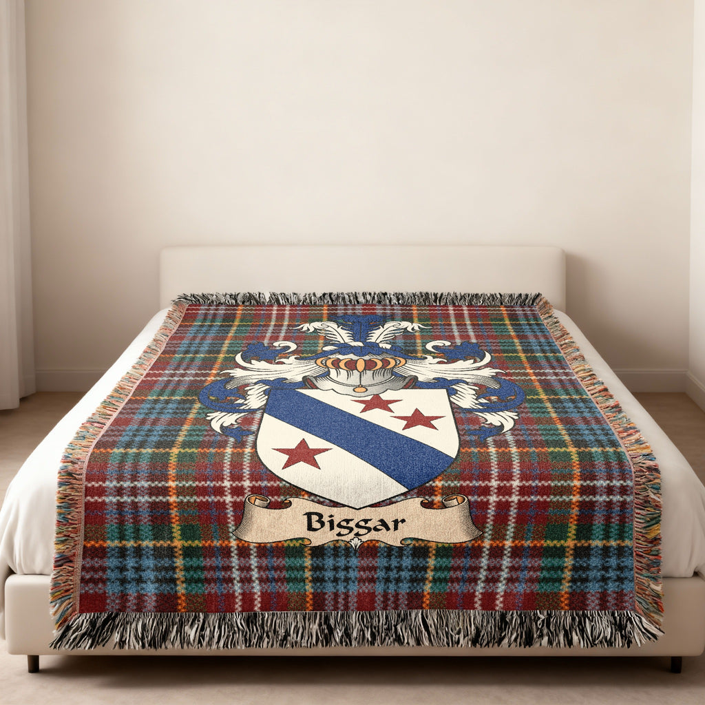 Biggar family crest emblem on a Caledonia tartan woven blanket
