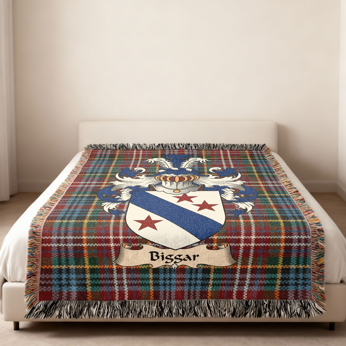 Biggar family crest emblem on a Caledonia tartan woven blanket