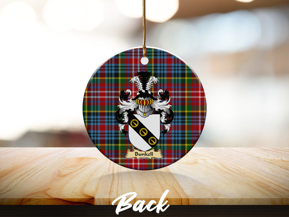 Round Bunkell Scottish clan ornament with family crest on a Caledonia tartan background