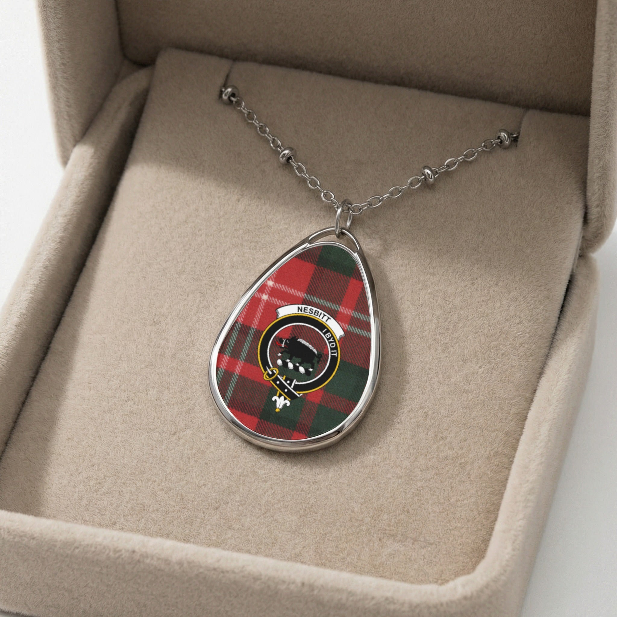 Oval pendant necklace with Nesbitt tartan, crest, and Latin motto on a ball chain.