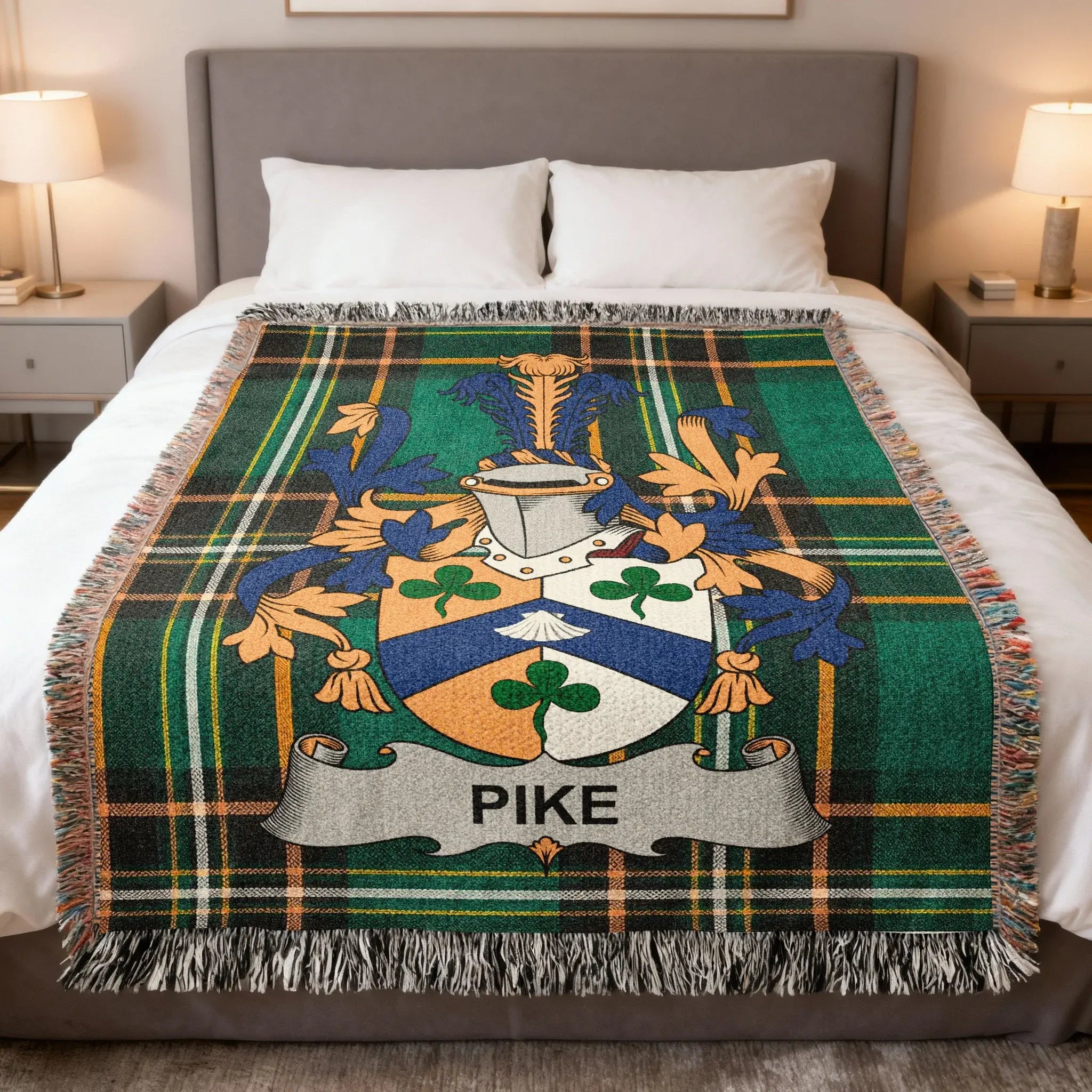 Tartan throw blanket featuring the Pike family crest on a bed.