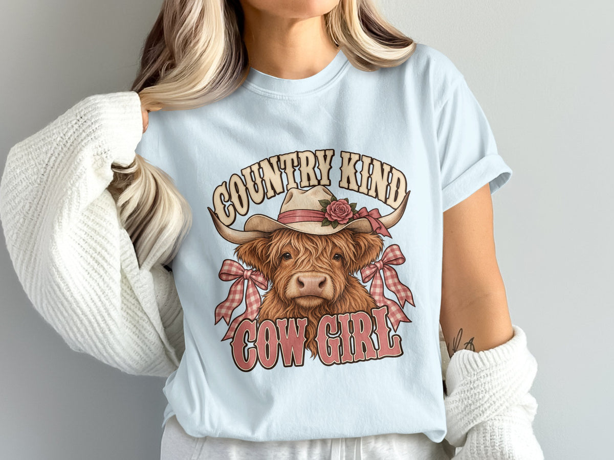 Model wearing the Country Kind Cow Girl Highland cow Comfort Colors T-shirt in Chambray
